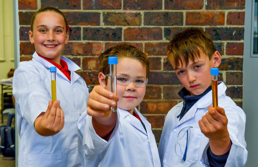 EXPERIMENT: Invermay Primary students Amber Semmens, Dylan Maher and Ashton Semmens, take part in The Smith Family's after school STEM learning club. Pictures: Scott Gelston