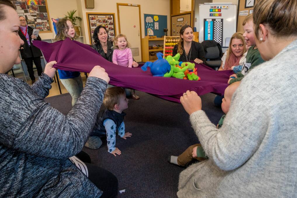 START EARLY: Mum Jessica Howe (left), with son Jasper, under the blanket, mum Ezra Ludwig with daughters Izzy and Simay, teacher Claire West, mum and teacher Jodie Claxton and daughter Scarlett, mum Ashley Peters with sons Harry and Noah. Picture: Phillip Biggs