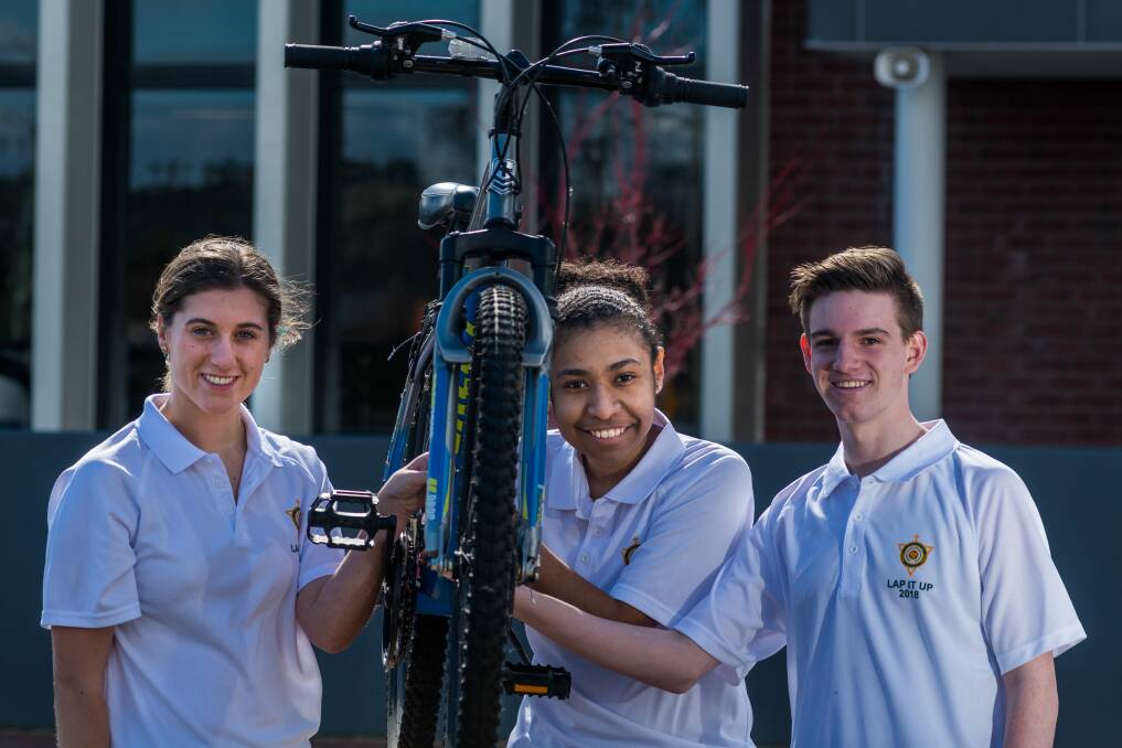 READY TO RIDE: St Patrick's College students Olivia Cullen, Yhollanda Bart and Damyon Bott prepare for the annual Lap it Up fundraiser, held at the school. Picture: Phillip Biggs