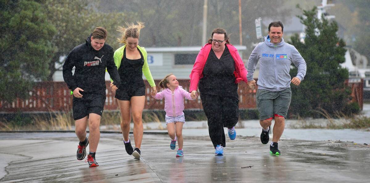 On the run: Triathlete Lockie Parker with the Wheatley family of Ava, Nella, Sophie and Matthew. Picture: Phillip Biggs