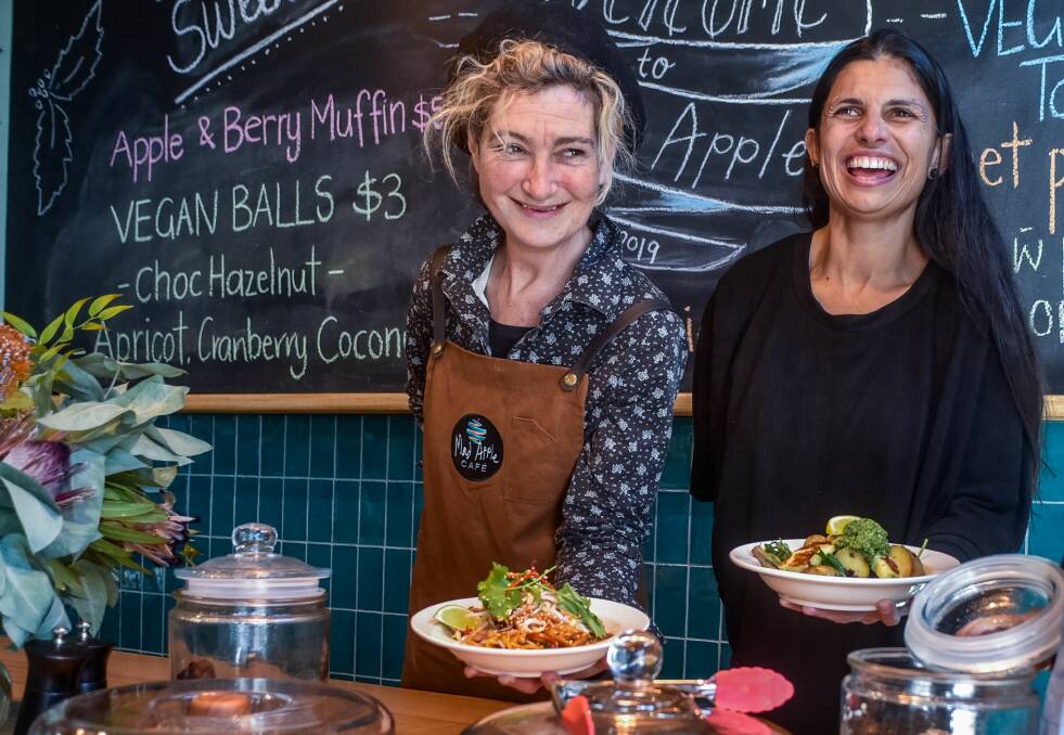 NEW EATERY: Naomi Nathan and Michelle Norton with two popular Mad Apple dishes. Picture: Neil Richardson 