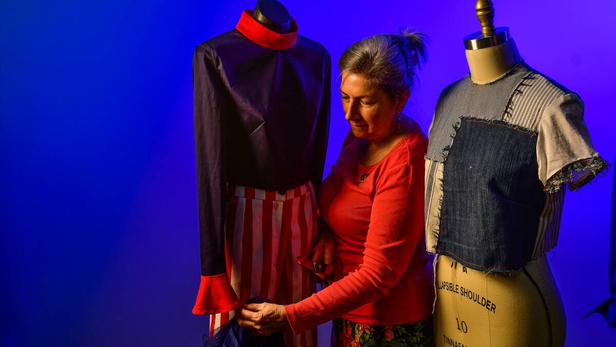 OCEANIC: Fashion and design student Chris Jenkins looks over creations for the Tassie Scallop Fiesta fashion parade. Picture: Scott Gelston