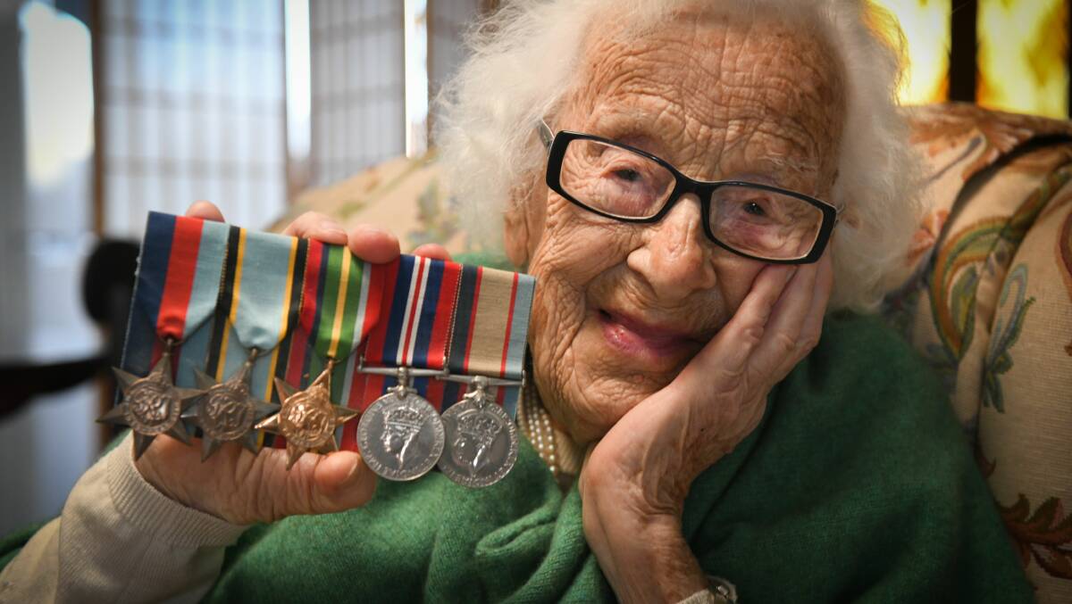 HONOURING SERVICE: Mrs Marjorie Fitzpatrick holds her brother Flight Lieutenant Dick Darcey's medals from when he flew Spitfires in World War II. Picture: Paul Scambler