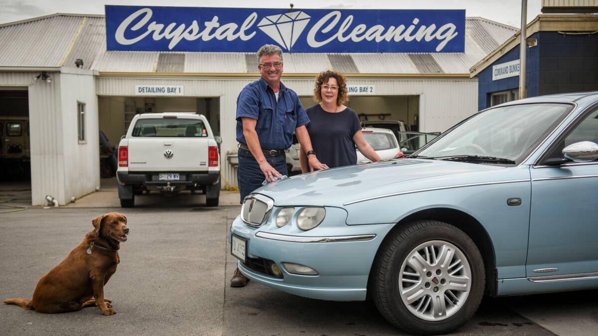 BUSINESS NOUS: Geoff and Tanya Hann with Win the dog at Crystal Cleaning in Cimitiere Street, Launceston. Picture: Paul Scambler
