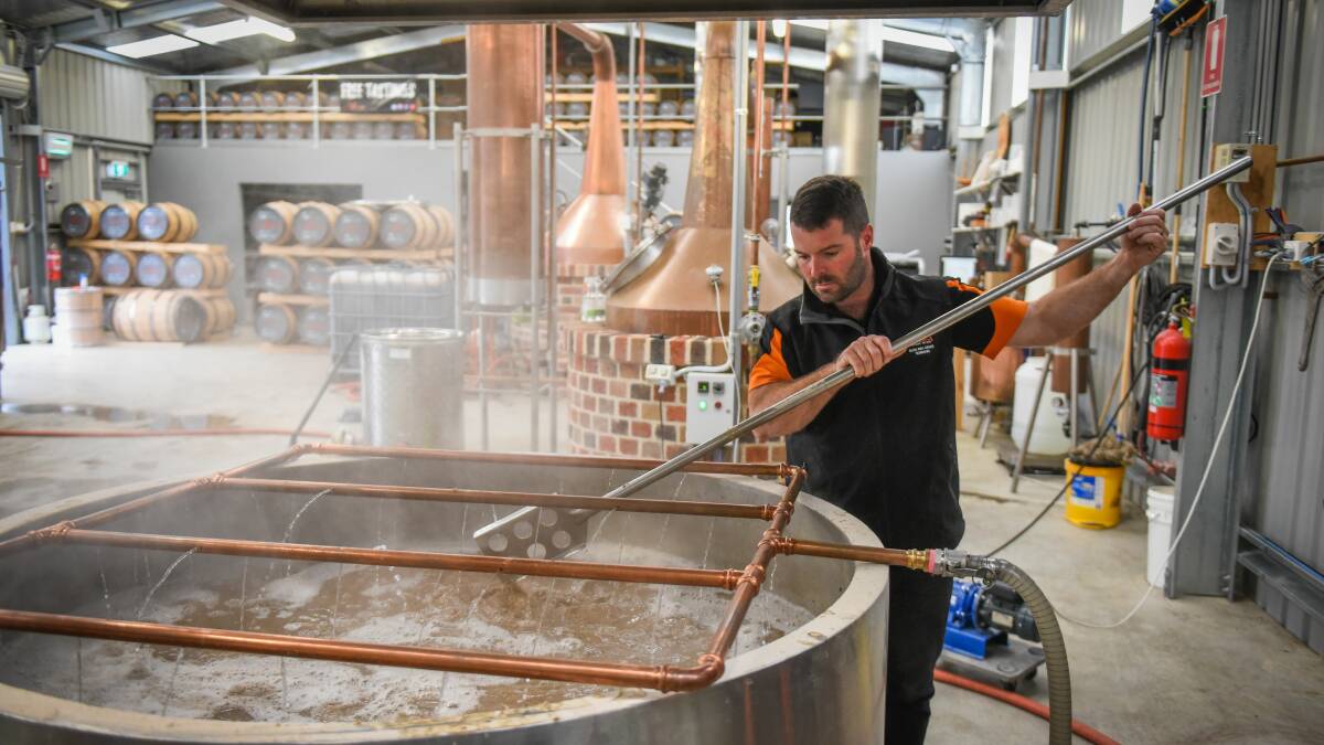 FORMAL QUALIFICATION COMING: Adam Saunders, of Adams Distillery, stirs the whisky mash as part of the spirit fermentation process. Picture: Paul Scambler