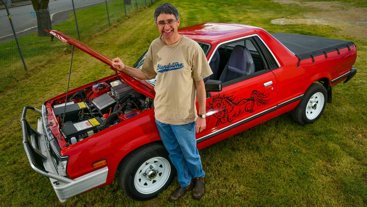 CHARGING UP: Christopher Walkden at Launceston Showground with his 1992 Subaru Brumby that was converted to electric. Picture: Scott Gelston