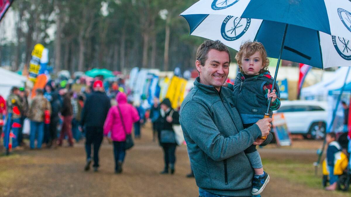 BRING YOUR BROLLY: Devonport's Gary and Willem Jordan, 2, were prepared for rain at Agfest 2017. Picture: Scott Gelston