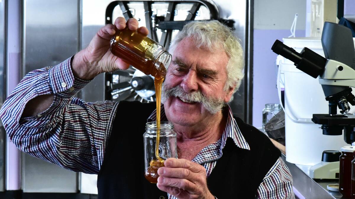 LEATHERWOOD STOCKS DECLINING: Beekeeper Lindsay Bourke pours his award-winning leatherwood honey. Tasmanian honey yield is only at 60 per cent this year due to low levels of leatherwood and unseasonal weather. Picture: Neil Richardson