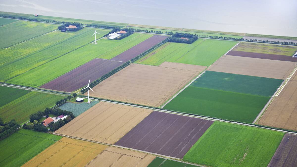 HIGHLY PRODUCTIVE: Farm landscape with windmill from above in The Netherlands. Picture: Shutterstock/Gigra