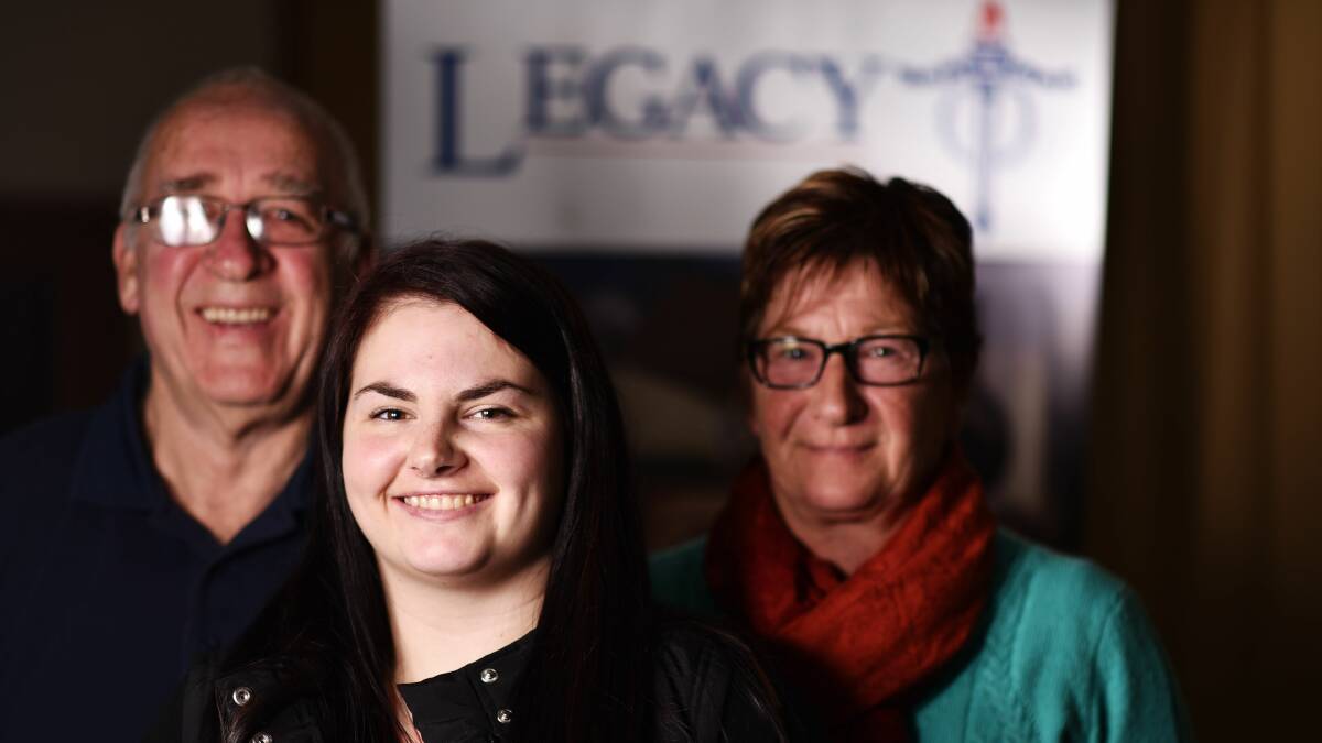 CONTINUING SUPPORT: Kelsey Breward stands in front of Legacy's Kevin Evorall and her mother, Maree Breward, in 2015. Picture: Scott Gelston