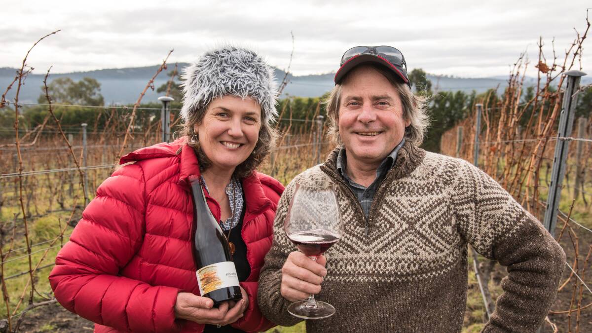 Monique and Steve Lubiana celebrate their third international win with a bottle of Ruscello Pinot Noir 2016 at their Granton vineyard. Picture: Supplied