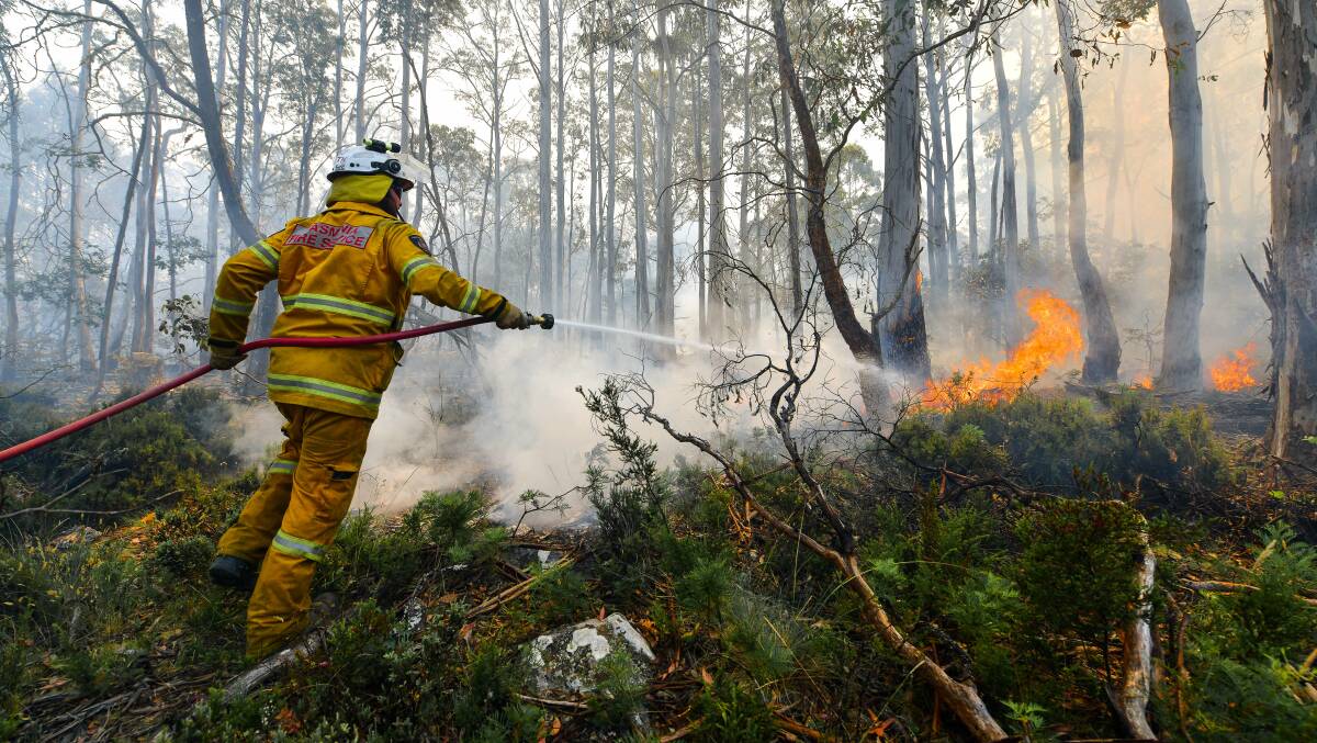 BE PREPARED: Dilston Fire Brigade's Adam Smith fighting the Great Pine Tier fire in the Central Highlands in January. Pictures: Scott Gelston