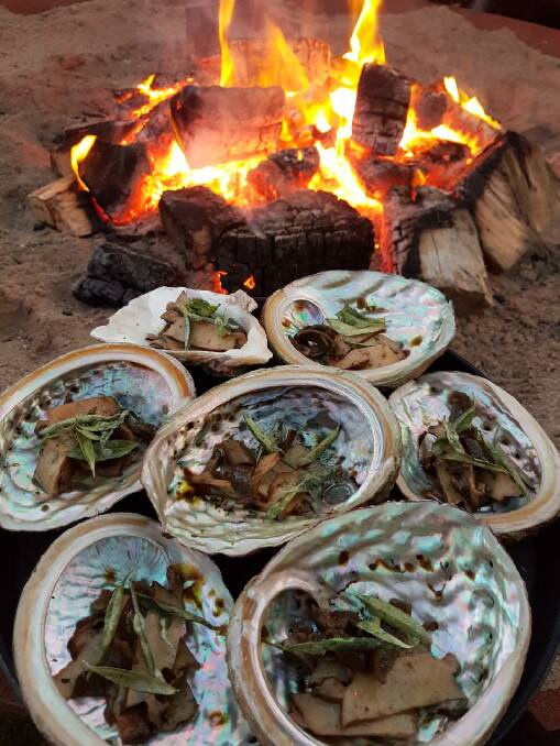 Abalone cooking on an open fire. Picture: Supplied