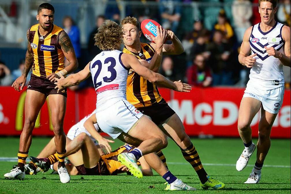 Now retired Hawthorn star and soon to be Hawthorn coach Sam Mitchell is chased by then Fremantle forward Chris Mayne. Picture: Phillip Biggs