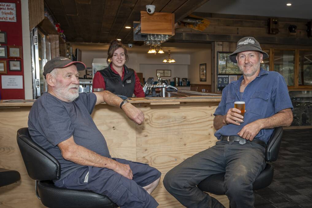 LAID BACK: Top - Central Highlands Lodge bar operator Jamie Miller pours Miena locals Brian "Beagle" Gardner and Tim Nolan a beer. Below - A typical Great Lake shack. Pictures: Craig George