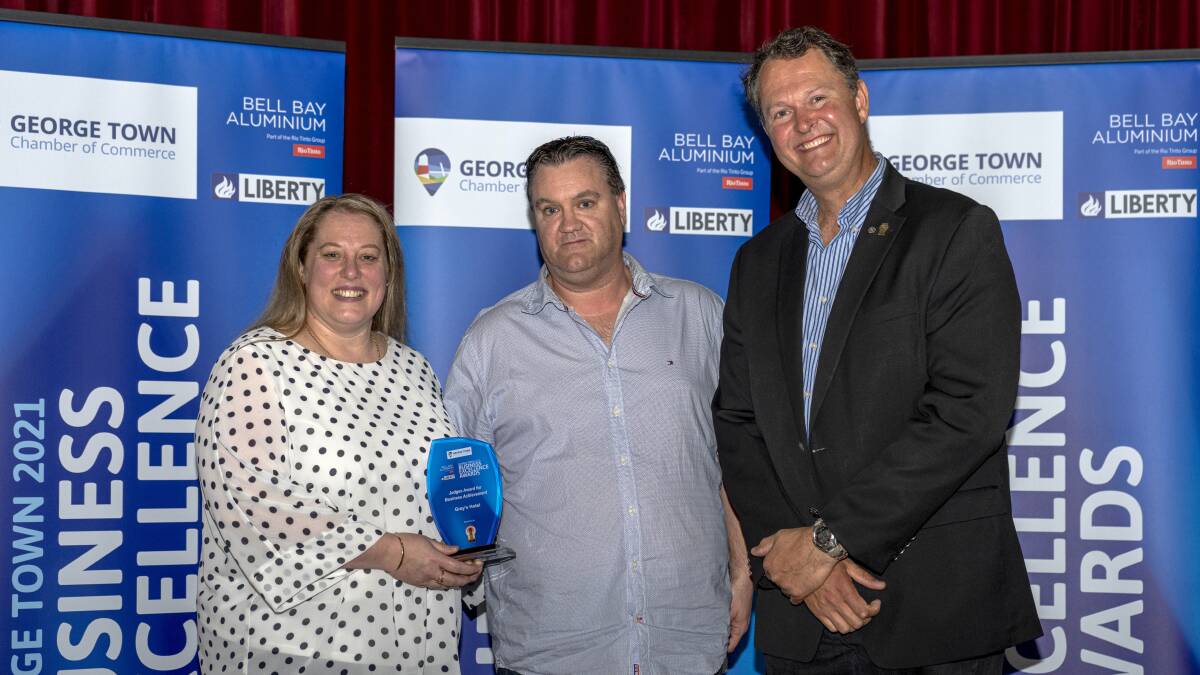 CHICKEN DINNER: Judges Award, Business Achievement winners Kate and Shaun Barnard from Gray's Hotel with George Town Mayor Greg Kieser. Picture: Supplied