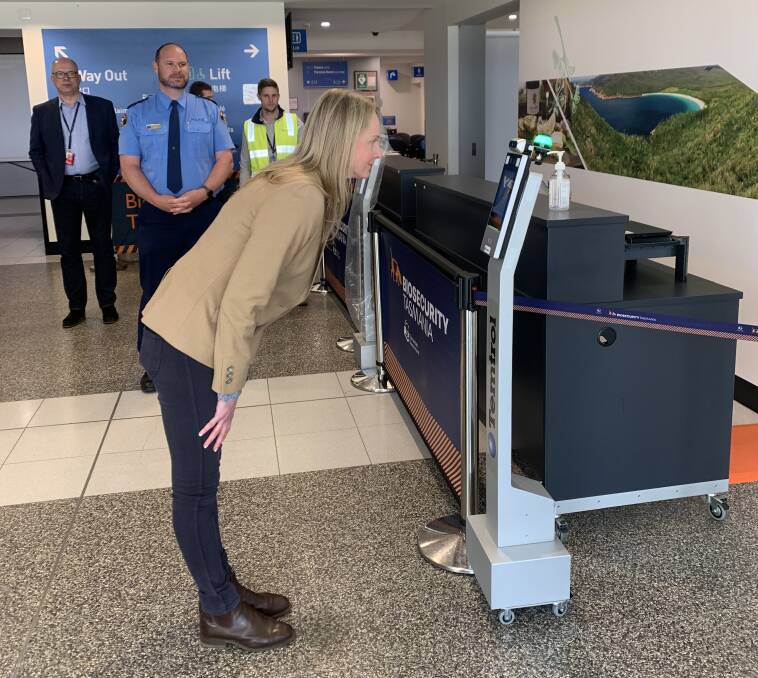 Health Minister Sarah Courtney tries out one of the body temperature testing systems in place at Launceston airport. Picture: Brinley Duggan.