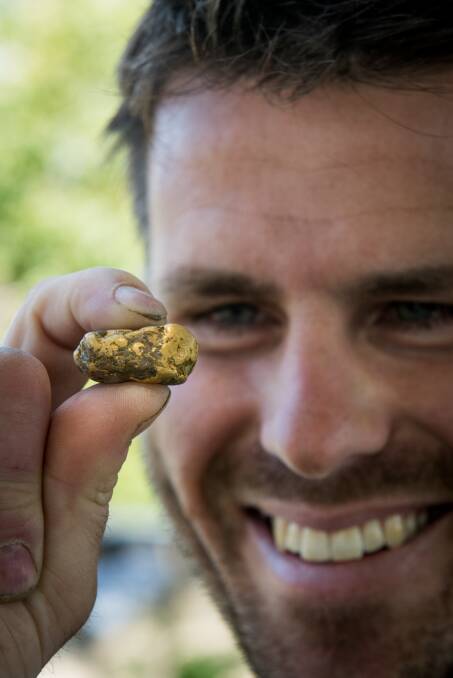 LEVI'S GOLD: Levi Triffitt with the largest gold nugget he has found while prospecting in Tasmania. Picture: Paul Scambler