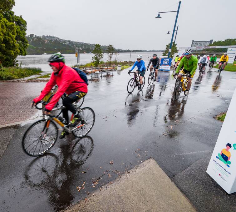 Tyred and wet: Riders had to deal with the elements at the start of Sally's Ride. Picture: Phillip Biggs.