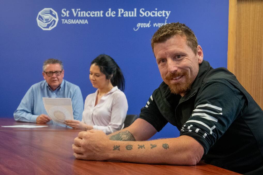 Heath Nash says things are looking better after the hardest period of his life. Mr Nash sits in front of Community Programs Officer Samantha Grace and Christmas Hamper coordinator Eric Welsh. Picture: Paul Scambler