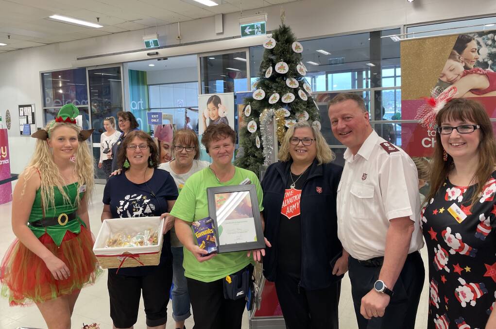 Christmas cheers: Kmart employees give Salvation Army representatives Anita Reeve and Kevin Lumb a certificate of appreciation at the launch of the Wishing Tree. Picture: Brinley Duggan.