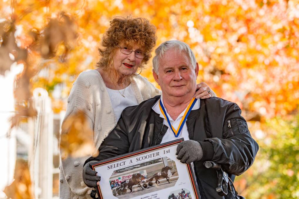WELL TRAVELLED: Ellen and Brian Mountney with a picture of their race horse Select A Scooter. Picture: Phillip Biggs