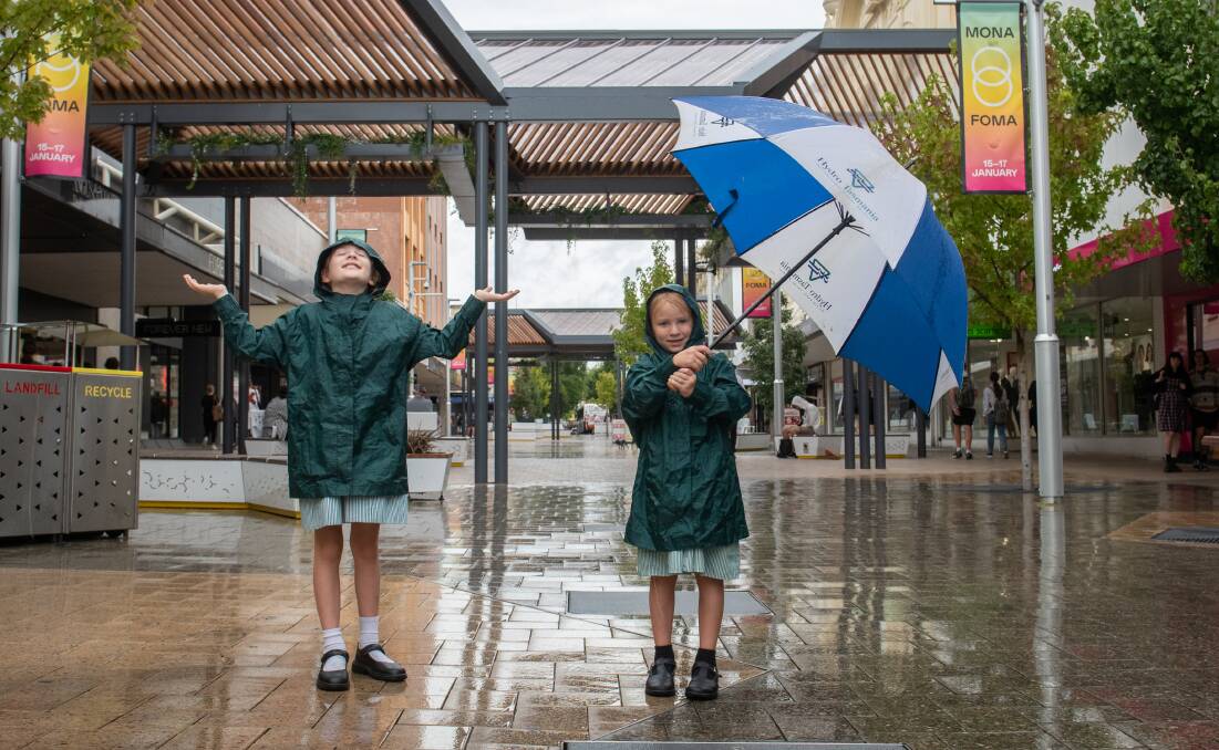 WEATHER...or not: Sophie Pennington, 8, and sister Lucy, 6, of Launceston in the Brisbane Street mall. Picture: Paul Scambler