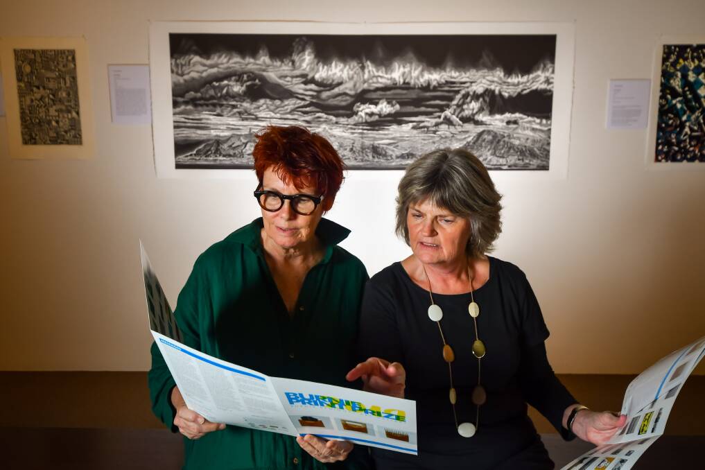 THE WINNER: Burnie Print Prize judge Tess Edwards and Burnie Regional Art Gallery director Dawn Oelrich with the winning piece "Gone fishing east of Faskrudsfjordur" a lino cut piece by Rew Hanks. Picture: Simon Sturzaker