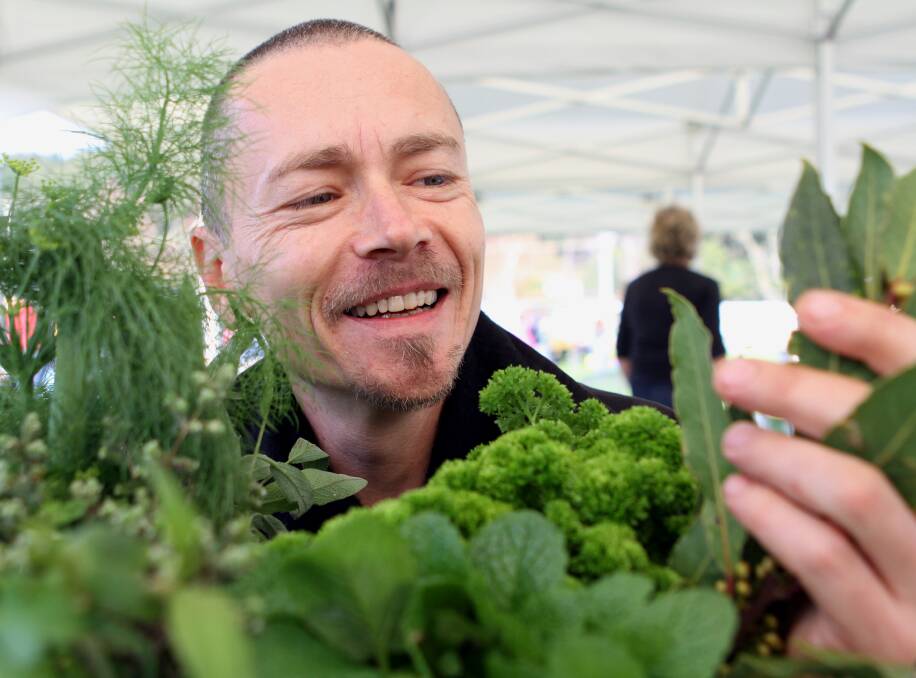 FESTIVALE: Television chef Simon Bryant tries some Tasmanian herbs and peppers at Burnie's Farmers Market in 2010. Picture: Peter Lord.