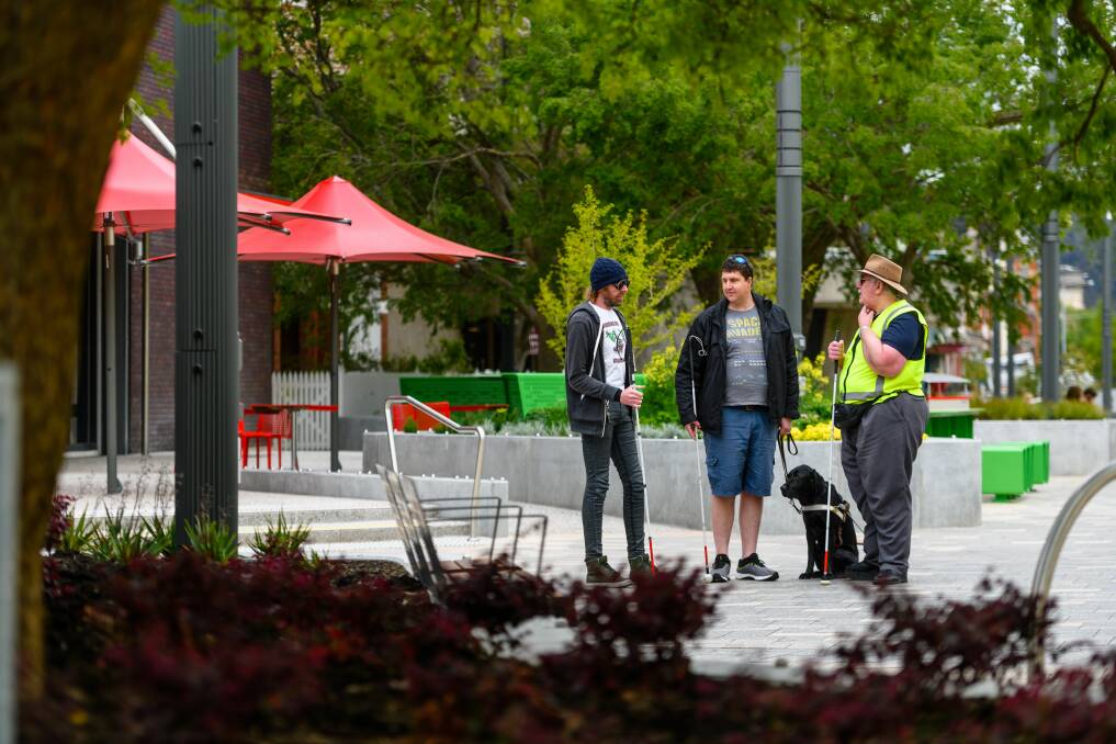 BE POLITE: James Newton, Rob Whyte and Greg Tutin, who use white canes, say people touch them without asking, and sometimes make them go in the wrong direction. Picture: Scott Gelston