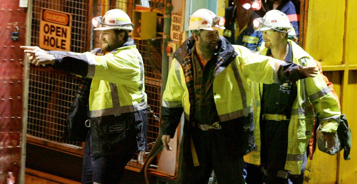 SURVIVORS: Brant Webb and Todd Russell leave the Beaconsfield Mine after 14 days trapped nearly a kilometre underground. Fellow miner, Larry Knight's funeral was held on the same day. Picture: Paul Scambler