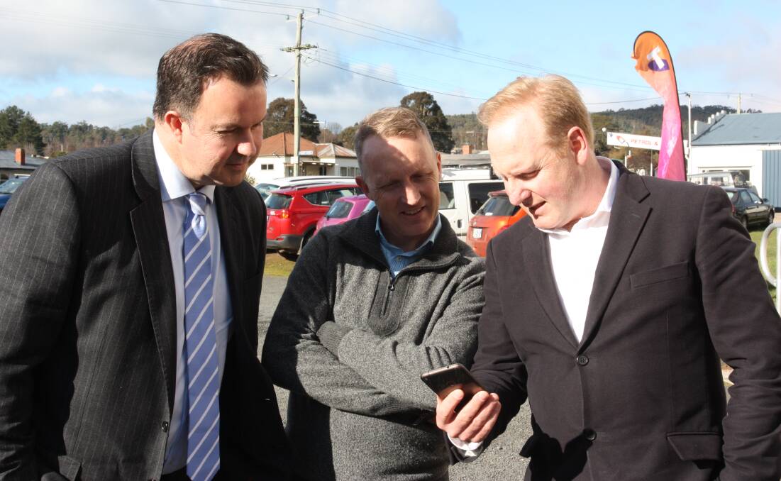 Liberal Senator for Tasmania David Bushby checks out the connection with Meander Valley Mayor Craig Perkins and Telstra Country wide General Manager Michael Patterson at the launch of the new Black Spot Mobile Phone Tower in Mole Creek. Picture: supplied