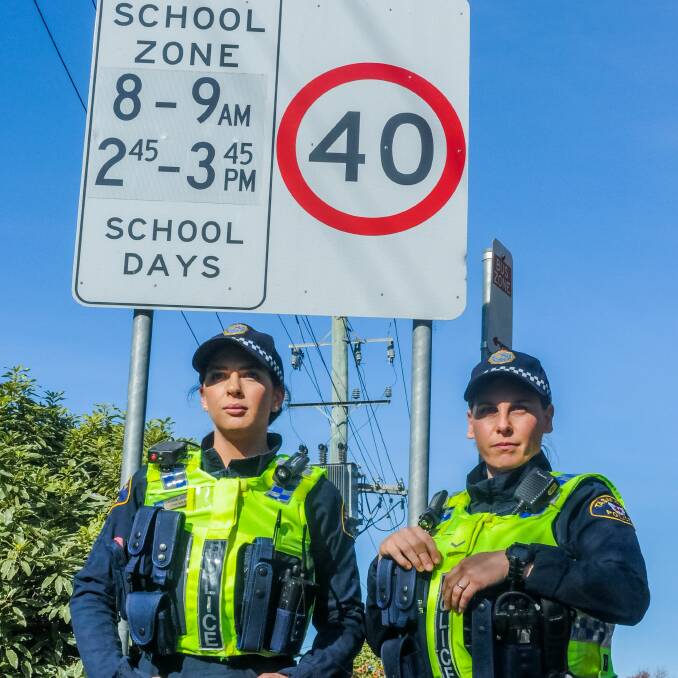 WATCHING: Tasmania Police Constable C Rawlings and first-class Constable J Rawlings keep their eyes up for speeding motorists in school zones. Picture: Neil Richardson