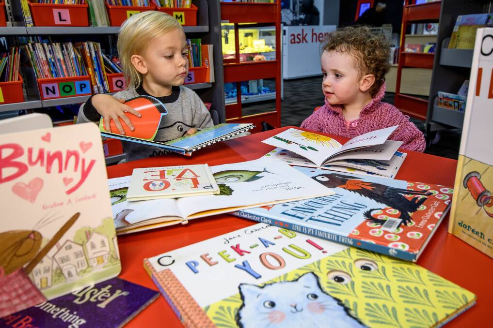 QUIET TIME: Drew Mowbray, 3, and Annabelle Hayes, 1, chat over some books at the Launceston LINC on Library Lovers Day. Picture: Scott Gelston