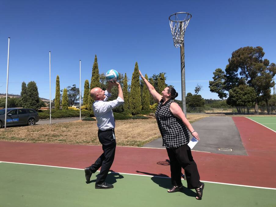 GOAL SHOOTER: Treasurer Peter Gutwein shoots for goal against NTNA chairwoman Michelle Cooley after announcing funding for court resurfacing. Picture: Tarlia Jordan
