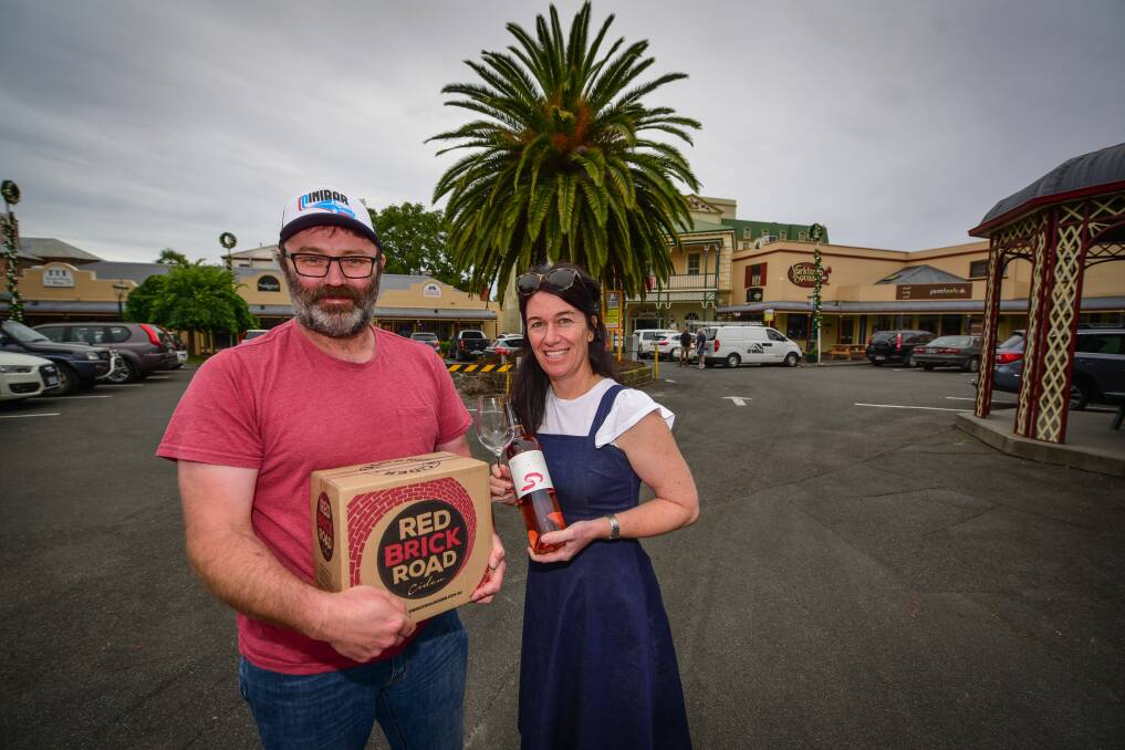 RELAX: Launceston Night Market organisers Corey Baker of Red Brick Road Cider and Natasha nuihowd of Goaty Hill Wines prepare for Friday's market. Picture: Paul Scambler