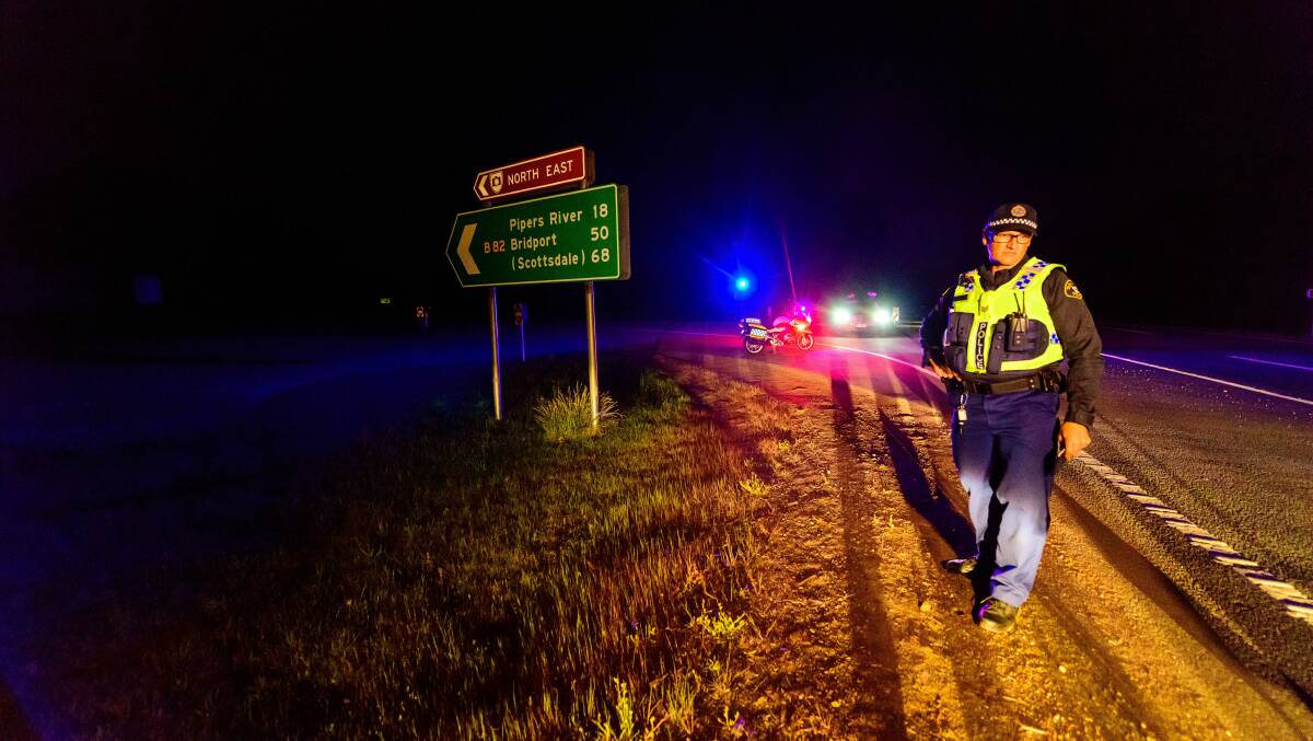 CLOSED: Tasmanian Police sergeant Dwayne Kirkby at the road block after a cattle truck crashed near George Town on Monday evening. Picture: Scott Gelston