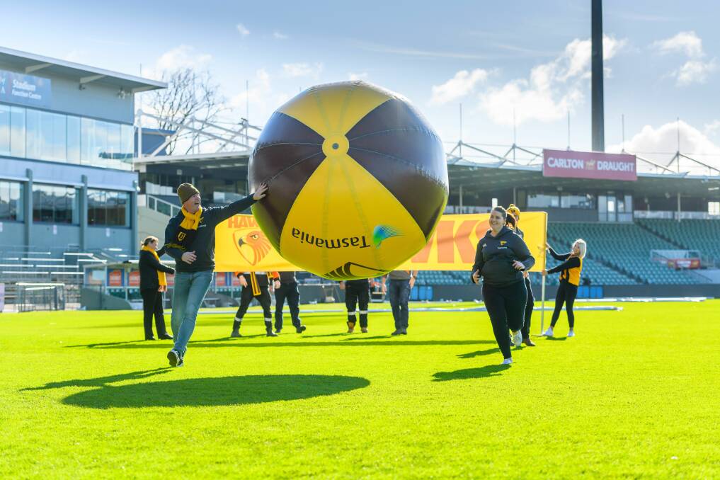 Hawthorn's Tasmanian staff get in some giant volleyball practice before Saturday's pre-game match between Ravenswood and Northern Suburbs community members, ahead of the round 17 clash between Hawthorn and Fremantle. Pictures: Scott Gelston