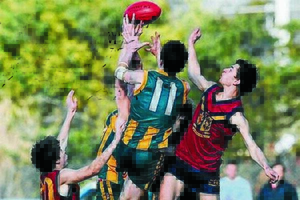  St Patrick's College captain Jake Laskey rides the pack in an attempt to pull down a mark in yesterday's state final against Scotch Oakburn.  Picture: WILL SWAN