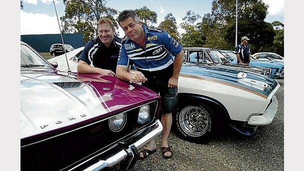 Tassie Muscle and Classic Car Cruise organiser Jon Chandler, of Scamander, talks cars with Grant Faulkner, of St Marys.