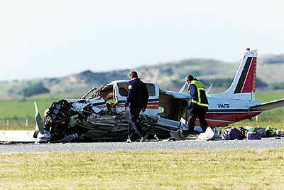 TRAGEDY: Investigators  examine the crash  scene at Currie yesterday.  Three Victorian  nurses died and three  were in a critical condition  after the accident.