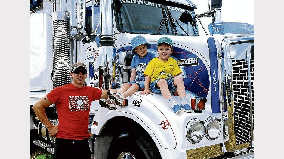 Dan Watson, of Deloraine, shows off his Kenworth 408 to son Hamish, 5, and Declan Youd, 4, at yesterday's Tasmanian Truck Show at Carrick's Quercus Rural Youth Park. Picture: NEIL RICHARDSON