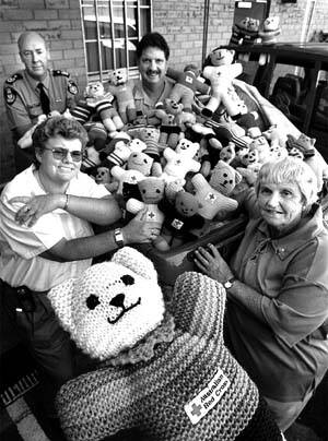 CUDDLY THOUGHTS: Red Cross volunteer Kim Brundle-Lawrence, Northern Red Cross president Bev Jackson, and fire brigade chief Michael Brown and district officer Andrew Comer look over the teddies for di