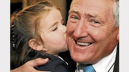 Geoff Lyons gets a kiss from granddaughter Grace Sheahan, 2, at the Tamar Yacht Club during last night's count.  Picture: PAUL SCAMBLER