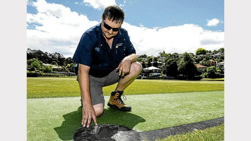 Trevallyn Cricket Club president Albert Letter inspecting damage to the pitch caused by fireworks ... the New Year's Eve vandalism could cost the club thousands of dollars but luckily the surface is still playable. Police are investigating the incident and are calling for public assistance. Picture: NEIL RICHARDSON