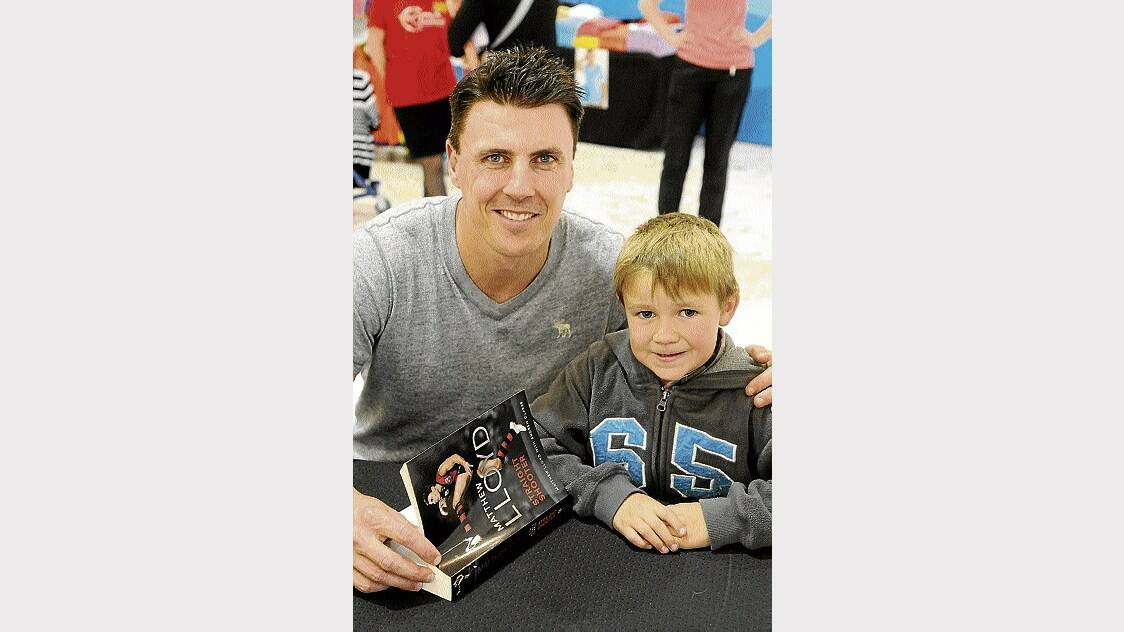Former Essendon player Matthew Lloyd with fan Jake McCarthy, 5, of Birralee, at his Launceston book signing yesterday. Picture: PAUL SCAMBLER
