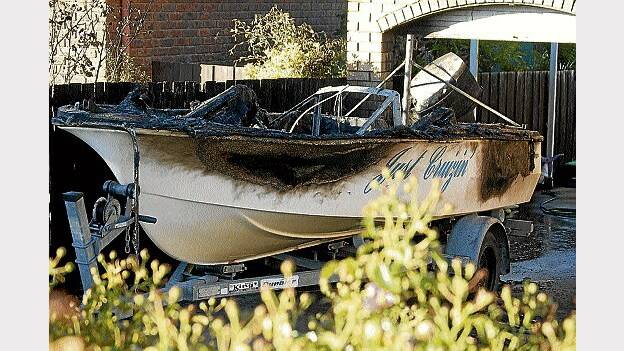 (u'The fire-damaged boat at a house in Leslie Grove, Prospect.',)