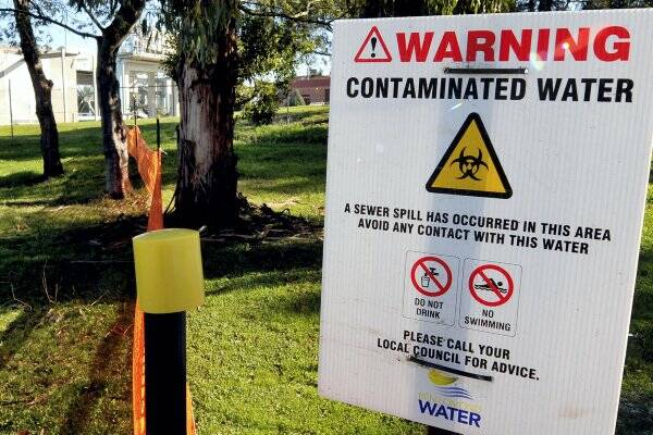 Signs warn the public of the sewage spill at the Hoblers Bridge wastewater treatment plant.   Picture: NEIL RICHARDSON
