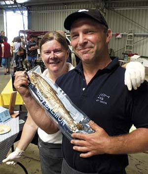 MEETING DEMAND: Angelika and Ziggy Pyka, of 41 Degree Aquaculture, with baby smoked salmon for sale at the Inveresk farmers' market yesterday.  Picture: WILL SWAN