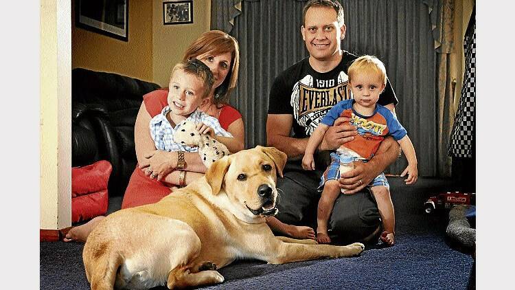 Louise and John Gibson, of East Devonport, with sons Bryce, 4, and Lachlan, 19 months, and companion dog Caleb. Picture: PHILLIP BIGGS